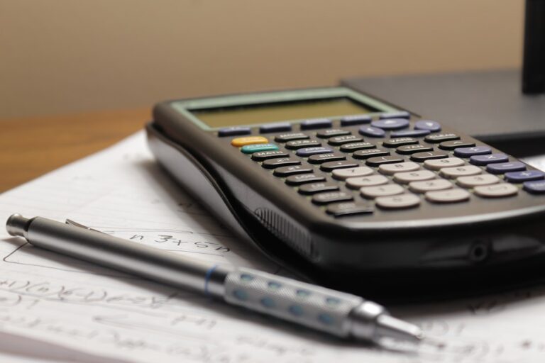 Calculator and paperwork used to price a cash home offer