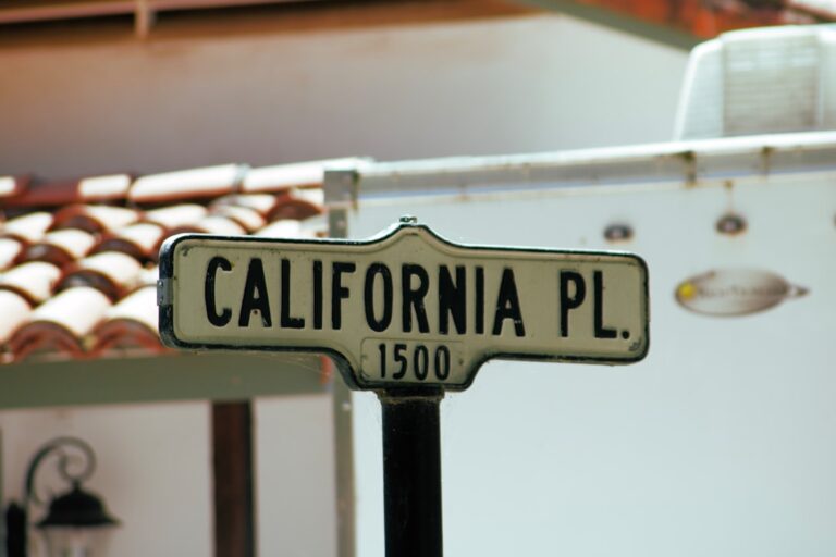 For sale sign in front of a suburban California house