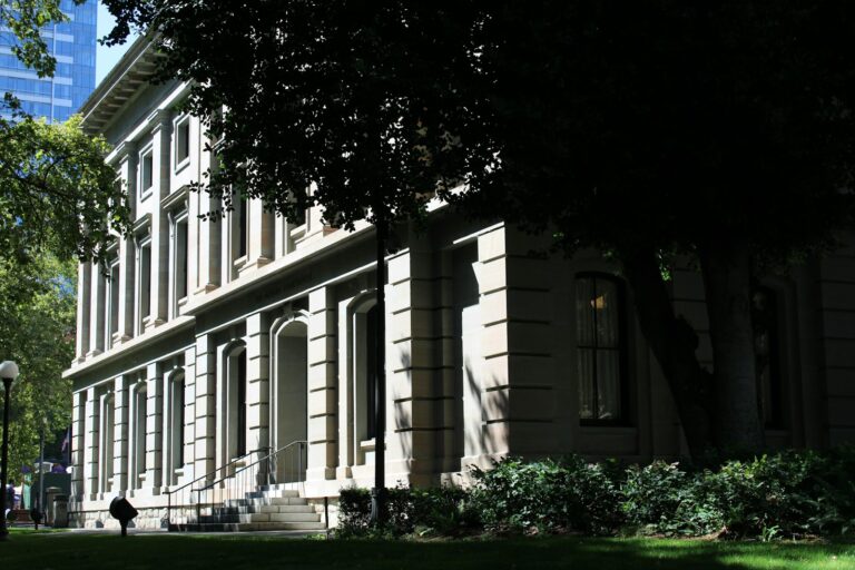 Sandstone facade and entry archways of a historic courthouse, representing California probate court confirmation of an estate property sale