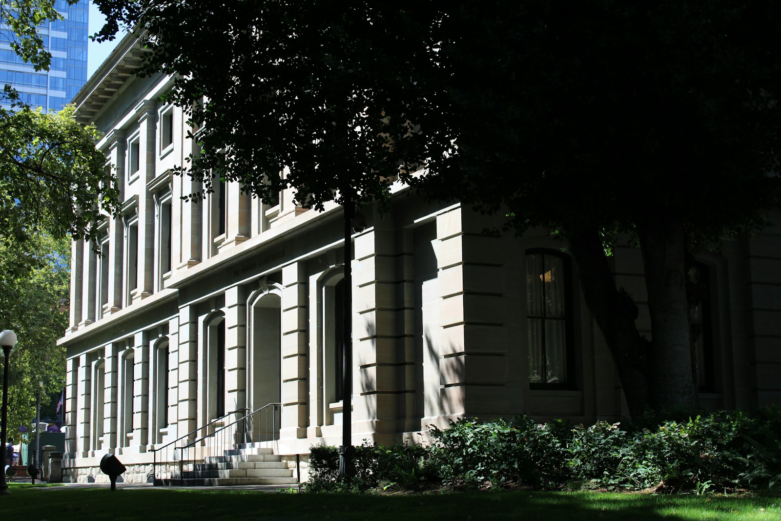 Sandstone facade and entry archways of a historic courthouse, representing California probate court confirmation of an estate property sale