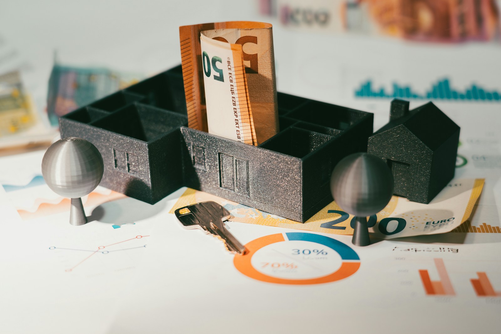 House model with banknotes and a door key representing protected home equity under the California homestead exemption