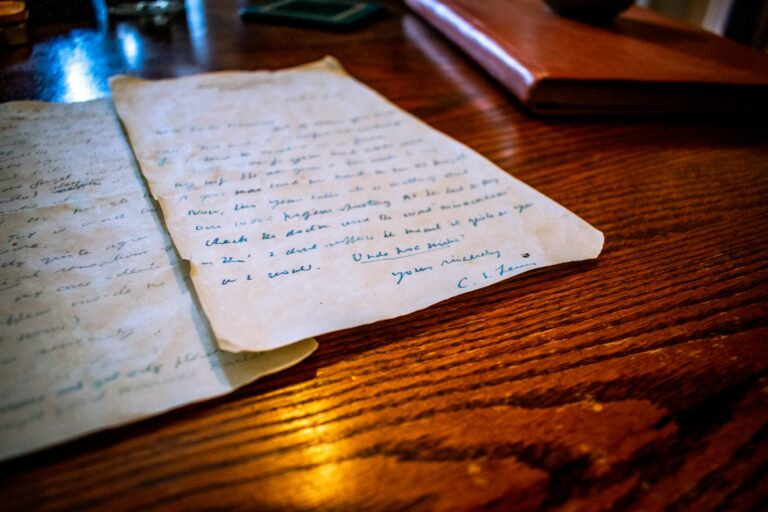 Aged handwritten property document on a wooden table representing an old cloud on title in California