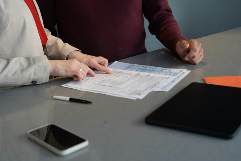 Two people reviewing tenancy paperwork, the due diligence an estoppel certificate is meant to verify