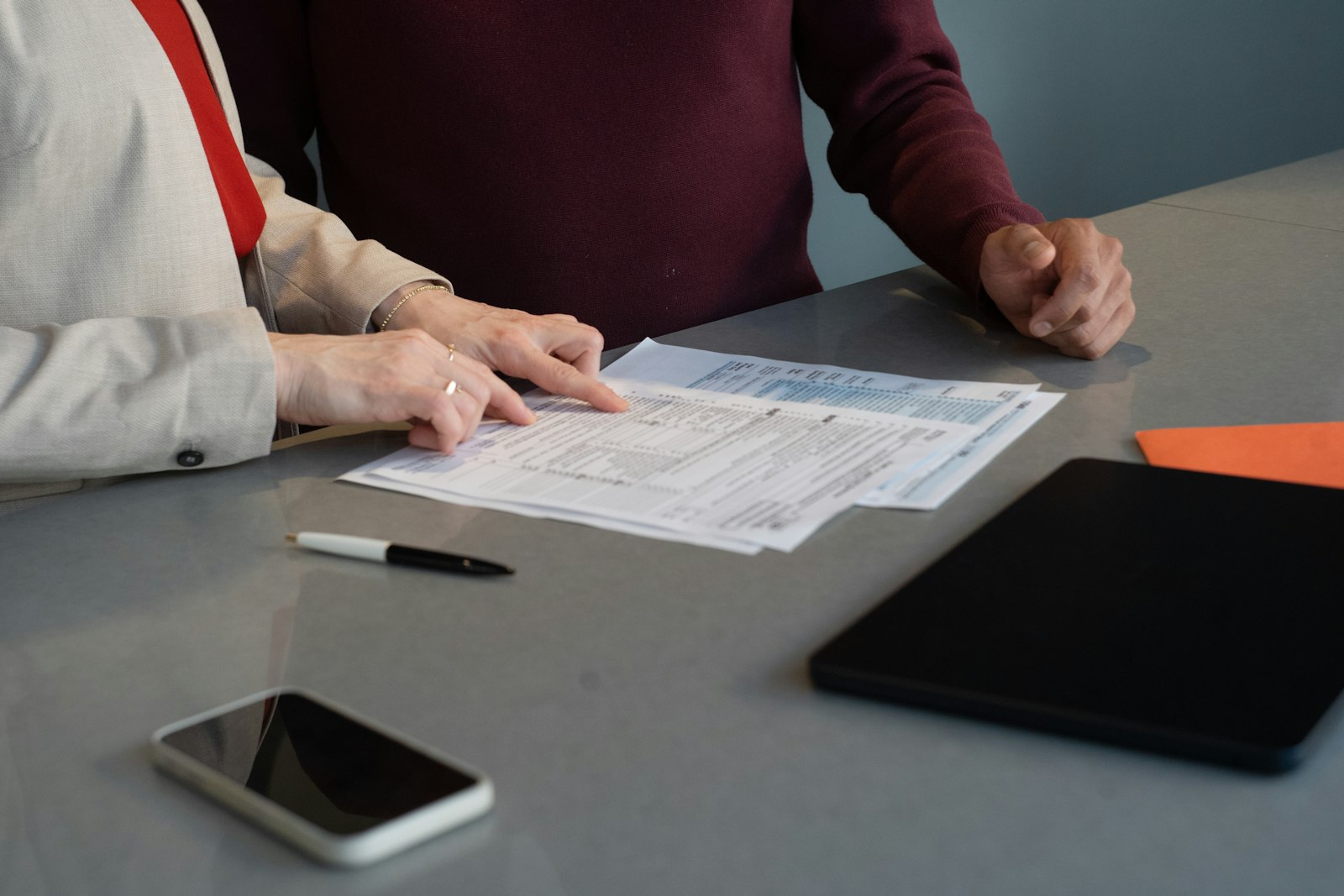 Two people reviewing tenancy paperwork, the due diligence an estoppel certificate is meant to verify