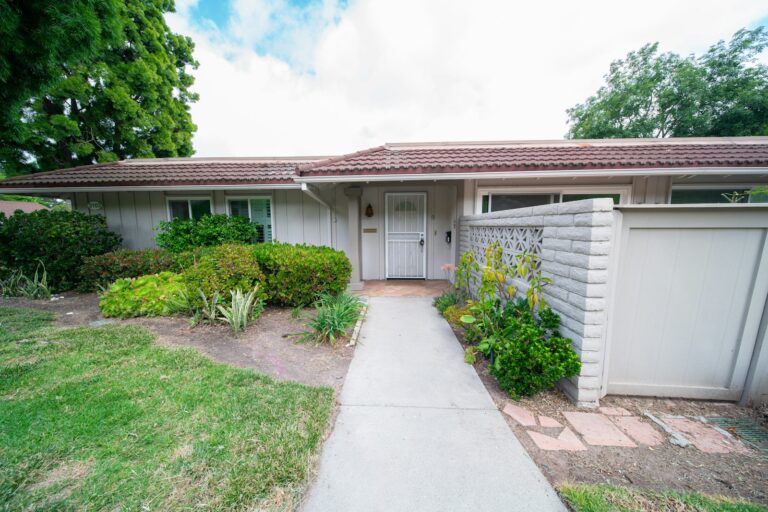 Front exterior of a single-family home with a white door and a sidewalk, illustrating a California property occupancy question
