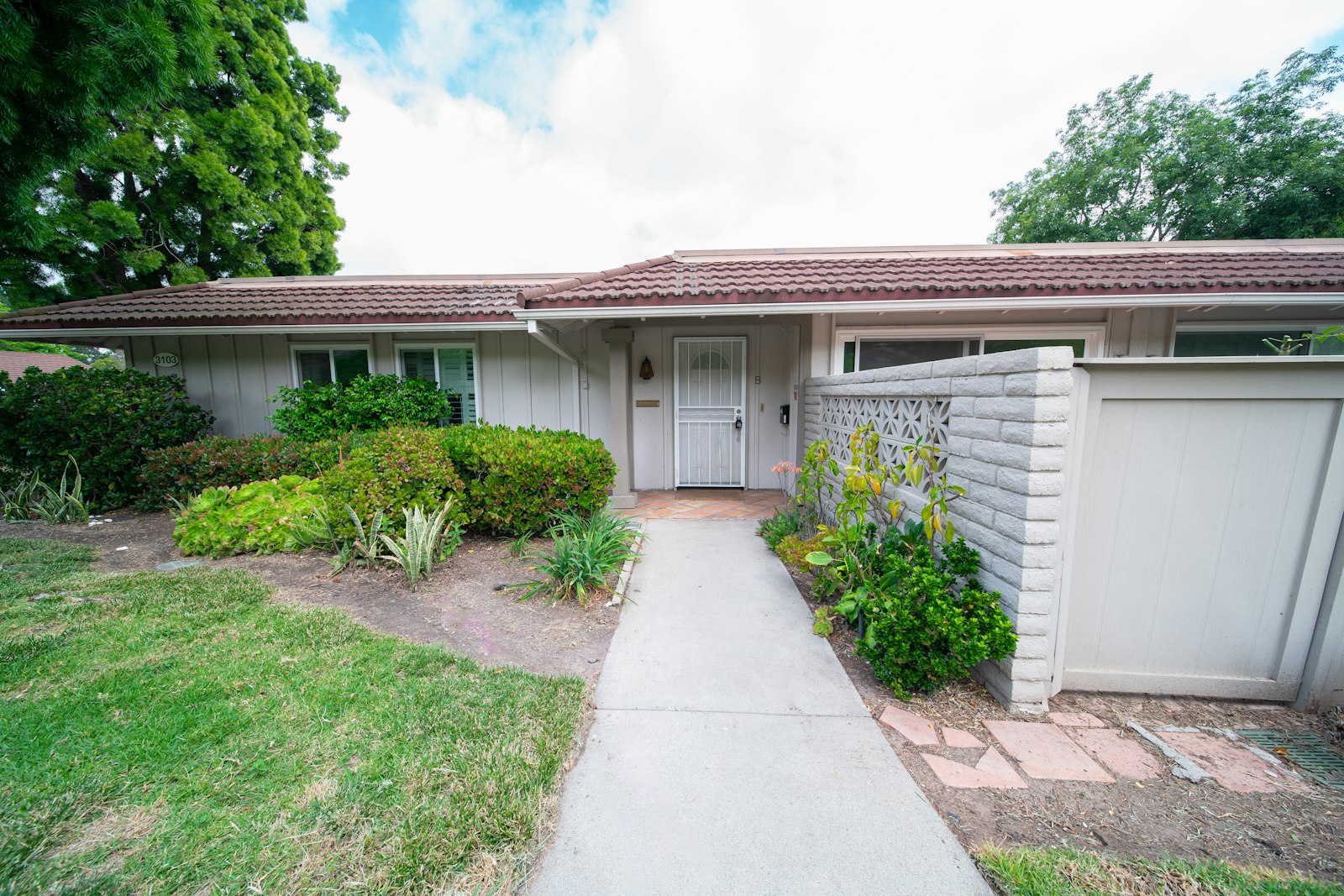 Front exterior of a single-family home with a white door and a sidewalk, illustrating a California property occupancy question