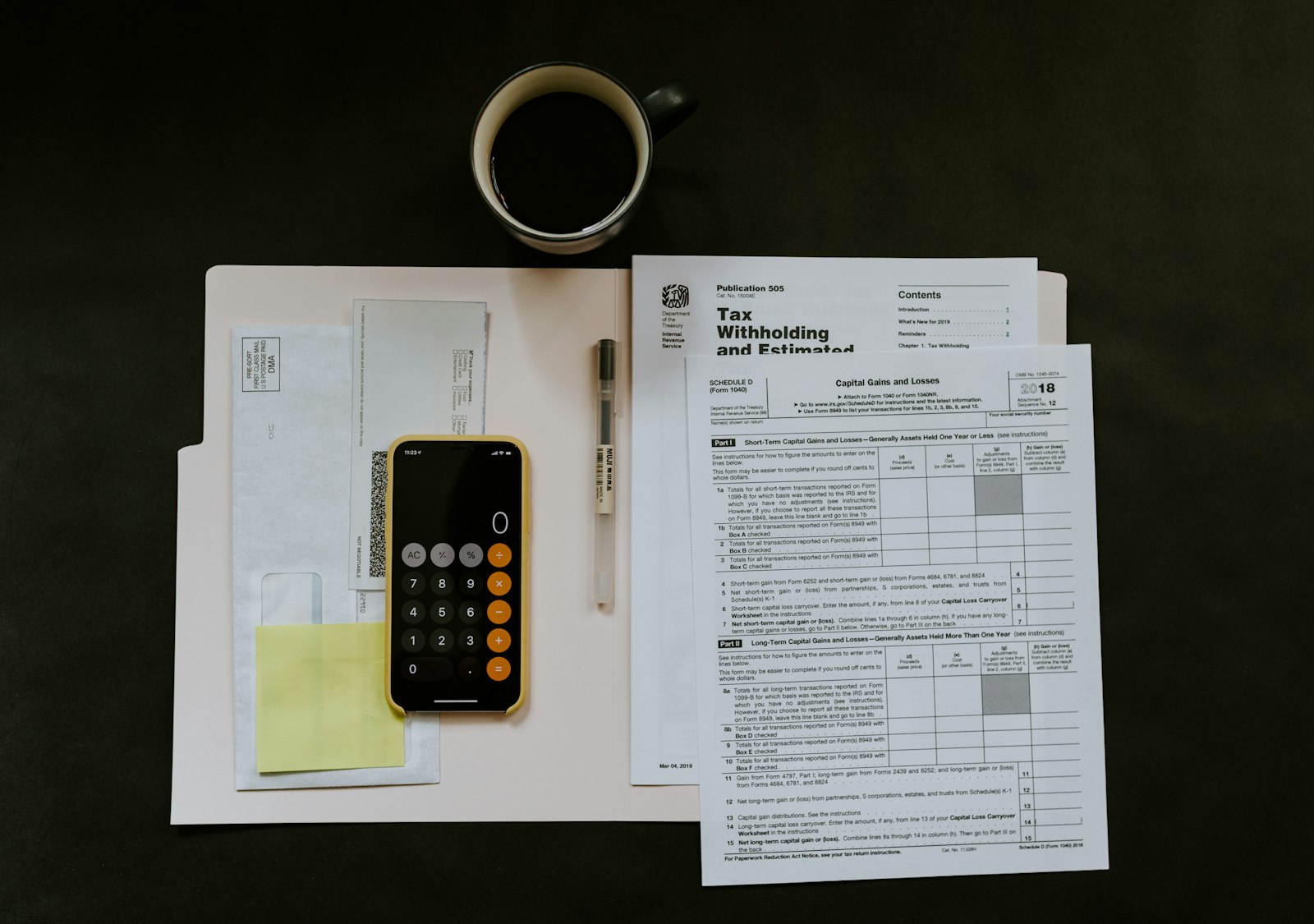 A tax statement, folder and pen on a desk, representing a delinquent California property tax bill and county redemption figures