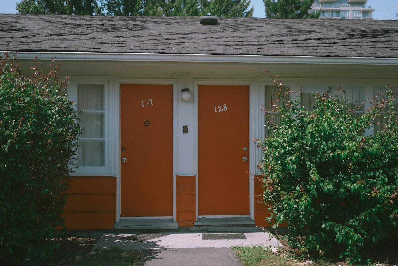 Numbered doors on a small apartment building, the kind of unit often rented month-to-month without a written lease