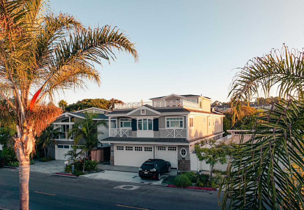 Two-story family home exterior with trees